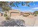 Street view of a single-story home featuring desert landscaping, tile roof, and an attached two-car garage at 13764 W Meeker Blvd, Sun City West, AZ 85375