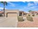 Charming single-story home featuring desert landscaping, tile roof, and an attached two-car garage at 13764 W Meeker Blvd, Sun City West, AZ 85375