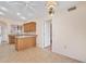 Bright kitchen featuring wood cabinets, tile flooring, breakfast bar and a ceiling fan at 13764 W Meeker Blvd, Sun City West, AZ 85375