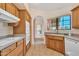 Bright kitchen featuring an undermount sink, wood cabinets, tiled floor, and modern appliances at 13764 W Meeker Blvd, Sun City West, AZ 85375