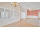 Open-concept living room with tile flooring, vaulted ceilings, and large windows at 13764 W Meeker Blvd, Sun City West, AZ 85375