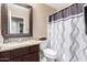 Well-lit bathroom with a granite countertop, a sink, modern fixtures, and a shower-tub combo at 1421 E Gary Dr, Chandler, AZ 85225