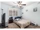 Cozy bedroom with light blue walls, carpet flooring, a ceiling fan, and a window with shutters at 1421 E Gary Dr, Chandler, AZ 85225