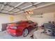 Spacious garage featuring a red sports car, ample storage, and an automatic door opener at 1421 E Gary Dr, Chandler, AZ 85225