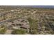 Aerial view of a desert estate, featuring solar panels, a pool, and lush landscaping at 15135 E Monument Rd, Scottsdale, AZ 85262