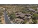 Stunning aerial shot of a large home with a desert landscape and private driveway at 15135 E Monument Rd, Scottsdale, AZ 85262