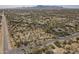 Aerial view of a desert landscape, with homes nestled amidst lush greenery at 15135 E Monument Rd, Scottsdale, AZ 85262