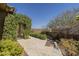 A serene backyard retreat featuring mature landscaping, hardscape, and views to the horizon at 15135 E Monument Rd, Scottsdale, AZ 85262