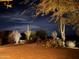 Outdoor patio at night showing cactus, desert landscape, and stone pavers at 15135 E Monument Rd, Scottsdale, AZ 85262