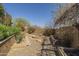 Beautiful backyard with gravel, unique plant life and desert landscaping, and fire pit seating area at 15135 E Monument Rd, Scottsdale, AZ 85262