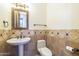 Elegant bathroom featuring tile walls, a pedestal sink and stylish accents at 15135 E Monument Rd, Scottsdale, AZ 85262