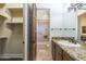 En-suite bathroom with granite counters, tile shower, and large closet at 15135 E Monument Rd, Scottsdale, AZ 85262