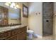 Bathroom featuring a granite vanity, walk-in shower, and neutral tones for a clean, serene experience at 15135 E Monument Rd, Scottsdale, AZ 85262