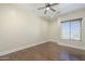 Comfortable bedroom featuring hardwood flooring, recessed lighting, and a large bright window at 15135 E Monument Rd, Scottsdale, AZ 85262