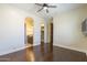 Spacious bedroom featuring an attached bath, ceiling fan, and hardwood flooring at 15135 E Monument Rd, Scottsdale, AZ 85262