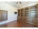 Bedroom featuring hardwood flooring, a ceiling fan, and custom built-in shelving at 15135 E Monument Rd, Scottsdale, AZ 85262