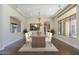 Professionally staged dining room with hardwood floors and a large bright window at 15135 E Monument Rd, Scottsdale, AZ 85262