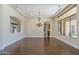 Formal dining room with hardwood floors, tray ceiling, and chandelier at 15135 E Monument Rd, Scottsdale, AZ 85262