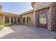 Stunning desert home featuring a private, brick-paved front courtyard with a decorative iron gate at 15135 E Monument Rd, Scottsdale, AZ 85262