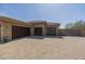 Expansive three-car garage with brick paver driveway on a sunny day at 15135 E Monument Rd, Scottsdale, AZ 85262