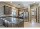 Kitchen boasts granite counters, stainless appliances, breakfast bar and wood cabinets offering a blend of style and functionality at 15135 E Monument Rd, Scottsdale, AZ 85262