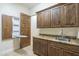 Convenient laundry room featuring granite countertops, ample cabinet space, and a built-in ironing board at 15135 E Monument Rd, Scottsdale, AZ 85262