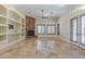 Living room featuring tile floors, stone fireplace, built-in shelves, and a ceiling fan at 15135 E Monument Rd, Scottsdale, AZ 85262