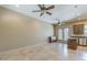 Bright, open-concept living room featuring tile floors, ceiling fans, and access to an outdoor area, showcasing a spacious layout at 15135 E Monument Rd, Scottsdale, AZ 85262