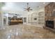 Open-concept living room with stone fireplace, built-in shelves, and easy access to the kitchen at 15135 E Monument Rd, Scottsdale, AZ 85262