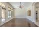 Living room featuring hardwood floors and a large bright window and archway at 15135 E Monument Rd, Scottsdale, AZ 85262