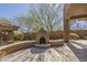 Outdoor courtyard with tiled patio, wood burning oven and spiral staircase at 15135 E Monument Rd, Scottsdale, AZ 85262