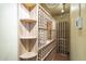 A custom wine cellar with wooden racks and shelving offering ample storage for wine bottles and bar items at 15135 E Monument Rd, Scottsdale, AZ 85262