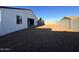 View of the spacious backyard showing the block wall and covered patio of this new construction home at 15781 W Cheryl Dr, Waddell, AZ 85355