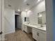 Bathroom with double sinks, white cabinets, and modern fixtures at 15781 W Cheryl Dr, Waddell, AZ 85355