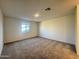 Comfortable bedroom with neutral carpet and a window providing natural light at 15781 W Cheryl Dr, Waddell, AZ 85355