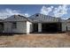 Exterior view of a house under construction with scaffolding showing the layout of the entryway and garage at 15781 W Cheryl Dr, Waddell, AZ 85355