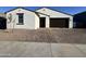 Charming single-story home with a stucco exterior and a well-maintained front yard at 15781 W Cheryl Dr, Waddell, AZ 85355