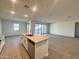 Open kitchen layout featuring a center island and a seamless flow into the living area at 15781 W Cheryl Dr, Waddell, AZ 85355