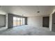 An interior view of a living room featuring large sliding glass doors and unfinished drywall, ready for customization at 15781 W Cheryl Dr, Waddell, AZ 85355