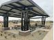 Modern picnic area with a covered structure and several picnic tables for community gatherings at 15781 W Cheryl Dr, Waddell, AZ 85355