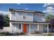 Charming two-story home showcasing a bright orange front door and inviting front porch at 16875 N 12Th St # 32, Phoenix, AZ 85022