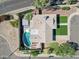 Aerial view of backyard featuring a pool, putting green, and covered patio area at 1749 E Medlock Dr, Phoenix, AZ 85016