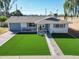 Inviting single-story home featuring a manicured lawn, charming details and a welcoming entrance at 1749 E Medlock Dr, Phoenix, AZ 85016