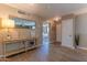 Inviting hallway with console table, decorative mirror, and doorway leading to the bedroom at 1749 E Medlock Dr, Phoenix, AZ 85016