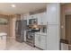 Spacious kitchen with stainless steel appliances and white cabinets offer a modern and clean design at 1749 E Medlock Dr, Phoenix, AZ 85016