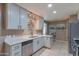 Well-lit kitchen with white cabinetry and stainless steel appliances, great design and layout at 1749 E Medlock Dr, Phoenix, AZ 85016