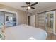 Spacious main bedroom with ceiling fan, closet and an ensuite bathroom that contains a glass enclosed shower at 1749 E Medlock Dr, Phoenix, AZ 85016