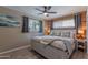 Charming main bedroom featuring wood accent wall, fan, and natural light from the window with stylish decorative pillows at 1749 E Medlock Dr, Phoenix, AZ 85016