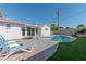 Inviting backyard featuring a refreshing pool, patio space, and lounging chairs at 1749 E Medlock Dr, Phoenix, AZ 85016