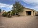 Well-maintained backyard featuring desert landscaping, a mature tree, and privacy at 17914 N Fiano Dr, Maricopa, AZ 85138